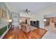 Well-lit living area with hardwood floors, an entertainment center, and an open layout at 1401 Ventana Dr, Sun City Center, FL 33573