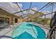 Sparkling screened-in pool and hot tub, perfect for relaxing and entertaining at 1401 Ventana Dr, Sun City Center, FL 33573