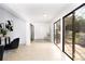 Well-lit hallway featuring tile floors, closet space, and access to outdoor views at 14810 Feather Cove Ln, Clearwater, FL 33762