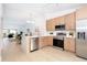 Modern kitchen with stainless steel appliances, light wood cabinetry, and an open floor plan at 14810 Feather Cove Ln, Clearwater, FL 33762