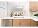 Bright kitchen featuring stainless steel appliances, quartz countertops, and modern pendant lighting at 14810 Feather Cove Ln, Clearwater, FL 33762