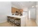 Modern kitchen features white countertops with a breakfast bar and barstool seating at 14810 Feather Cove Ln, Clearwater, FL 33762