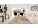 Cozy living room with neutral furniture, accent rug, and bright natural light at 14810 Feather Cove Ln, Clearwater, FL 33762