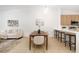 Bright dining area open to the kitchen and living space featuring light hardwood flooring at 14810 Feather Cove Ln, Clearwater, FL 33762