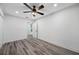 Neutral bedroom with durable floors, a ceiling fan, and a doorway leading to the ensuite bathroom at 16324 Bonneville Dr, Tampa, FL 33624