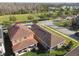 An aerial view shows houses, trees, a lake, and a park in a residential area at 17596 Terrazzo Way, Land O Lakes, FL 34638