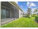 Exterior view of the screened in patio and green backyard at 17596 Terrazzo Way, Land O Lakes, FL 34638