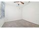 Bright bedroom with neutral carpet, ceiling fan, and window with blinds at 17596 Terrazzo Way, Land O Lakes, FL 34638