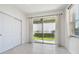 Bright bedroom with tile floors, large sliding glass door to patio, closet, and neutral walls at 17596 Terrazzo Way, Land O Lakes, FL 34638