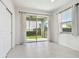 Bright bedroom with tile floors, large sliding glass door to patio, and window with blinds at 17596 Terrazzo Way, Land O Lakes, FL 34638