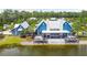 A blue house with a large deck overlooking a lake and surrounded by trees at 17596 Terrazzo Way, Land O Lakes, FL 34638