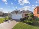 Aerial view of the front of home with brick driveway and manicured lawn at 17596 Terrazzo Way, Land O Lakes, FL 34638