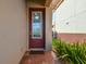 Elegant front door with decorative glass panel and sidelights, set within a brick-paved entryway at 17596 Terrazzo Way, Land O Lakes, FL 34638