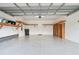 Bright and spacious garage with storage shelving on white walls at 17596 Terrazzo Way, Land O Lakes, FL 34638