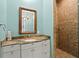 Bright bathroom featuring tiled shower, granite countertops, and white cabinetry at 2028 Illinois Ne Ave, St Petersburg, FL 33703