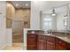 Bathroom shows granite countertop vanity and luxurious shower with dual showerheads at 2028 Illinois Ne Ave, St Petersburg, FL 33703