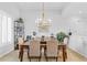 Dining room with a modern chandelier, a wooden table with seating for six, and neutral decor at 2028 Illinois Ne Ave, St Petersburg, FL 33703