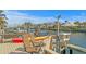 Waterfront dock featuring an outdoor seating area, kayaks, a boat, and views of the canal and nearby homes at 2028 Illinois Ne Ave, St Petersburg, FL 33703