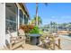 Patio area with a gas fire pit, chairs, nearby landscaping and home with water in the background at 2028 Illinois Ne Ave, St Petersburg, FL 33703