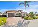 Stunning Mediterranean style home featuring a paver driveway, lush landscaping, and a two-car garage at 2028 Illinois Ne Ave, St Petersburg, FL 33703