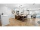 Bright kitchen featuring an island with seating, custom cabinetry, and travertine flooring at 2028 Illinois Ne Ave, St Petersburg, FL 33703