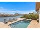 Waterfront pool with integrated spa and lounge chairs overlooking the waterway and boat docks at 2028 Illinois Ne Ave, St Petersburg, FL 33703