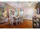 Open dining area features hardwood floors, a modern light fixture, and seamless flow to the living spaces at 2086 Whitney N Pl, Clearwater, FL 33760