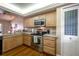 Cozy kitchen featuring stainless steel appliances, wood cabinets, and hardwood floors at 2086 Whitney N Pl, Clearwater, FL 33760