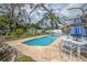 A serene pool with a jacuzzi and a lush, landscaped yard at 2086 Whitney N Pl, Clearwater, FL 33760