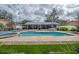 Backyard showcasing a pool and spa with ample space for outdoor activities and relaxation near the screened porch at 2086 Whitney N Pl, Clearwater, FL 33760