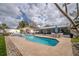 A refreshing pool and spa combo surrounded by a spacious patio area perfect for relaxation and backyard fun at 2086 Whitney N Pl, Clearwater, FL 33760