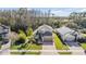 Aerial view of the home with well-manicured lawn and proximity to other neighborhood homes at 212 Arbor Woods Cir, Oldsmar, FL 34677