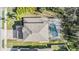 Overhead view of home with a backyard screened in pool and patio at 212 Arbor Woods Cir, Oldsmar, FL 34677