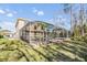 Relaxing screened-in pool with hot tub surrounded by lush landscaping at 212 Arbor Woods Cir, Oldsmar, FL 34677