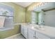 Bathroom with double vanity, white cabinets, and large mirror at 212 Arbor Woods Cir, Oldsmar, FL 34677