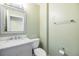 Bright bathroom features a white vanity with a marble countertop and framed mirror at 212 Arbor Woods Cir, Oldsmar, FL 34677