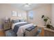 Staged bedroom showcasing a comfortable bed, stylish decor and a window at 212 Arbor Woods Cir, Oldsmar, FL 34677