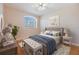 Staged bedroom featuring a tufted headboard bed, with blue bedding and decor at 212 Arbor Woods Cir, Oldsmar, FL 34677