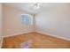 Bright bedroom with hardwood floors and a window at 212 Arbor Woods Cir, Oldsmar, FL 34677