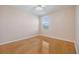 Empty bedroom with hardwood floors and a large window at 212 Arbor Woods Cir, Oldsmar, FL 34677