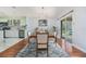 Charming dining room adjacent to the kitchen, featuring tile floors and sliding glass doors leading to the backyard at 212 Arbor Woods Cir, Oldsmar, FL 34677