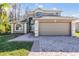 Charming two-story home with attached two-car garage and manicured landscaping at 212 Arbor Woods Cir, Oldsmar, FL 34677