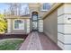 Stunning front exterior with brick walkway leading to the double door entry and manicured landscaping at 212 Arbor Woods Cir, Oldsmar, FL 34677