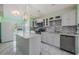 Bright kitchen featuring stainless steel appliances, white cabinets, and marble tile floors at 212 Arbor Woods Cir, Oldsmar, FL 34677