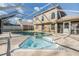 Relaxing screened-in pool and hot tub with brick-paved deck and a view of the home at 212 Arbor Woods Cir, Oldsmar, FL 34677