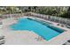 Community pool featuring plenty of lounge chairs and fenced in area for safety and privacy at 212 Arbor Woods Cir, Oldsmar, FL 34677