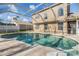 Inviting screened pool area with a view of the home's exterior at 212 Arbor Woods Cir, Oldsmar, FL 34677