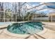 Sparkling screened-in pool and spa area with brick paver deck, perfect for outdoor entertaining and relaxation at 212 Arbor Woods Cir, Oldsmar, FL 34677