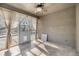 Light-filled sunroom with tile flooring, ceiling fan, and views of the outdoors at 212 Arbor Woods Cir, Oldsmar, FL 34677