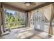 Inviting sunroom with tile flooring, large windows, and neutral decor offers bright, flexible space at 212 Arbor Woods Cir, Oldsmar, FL 34677